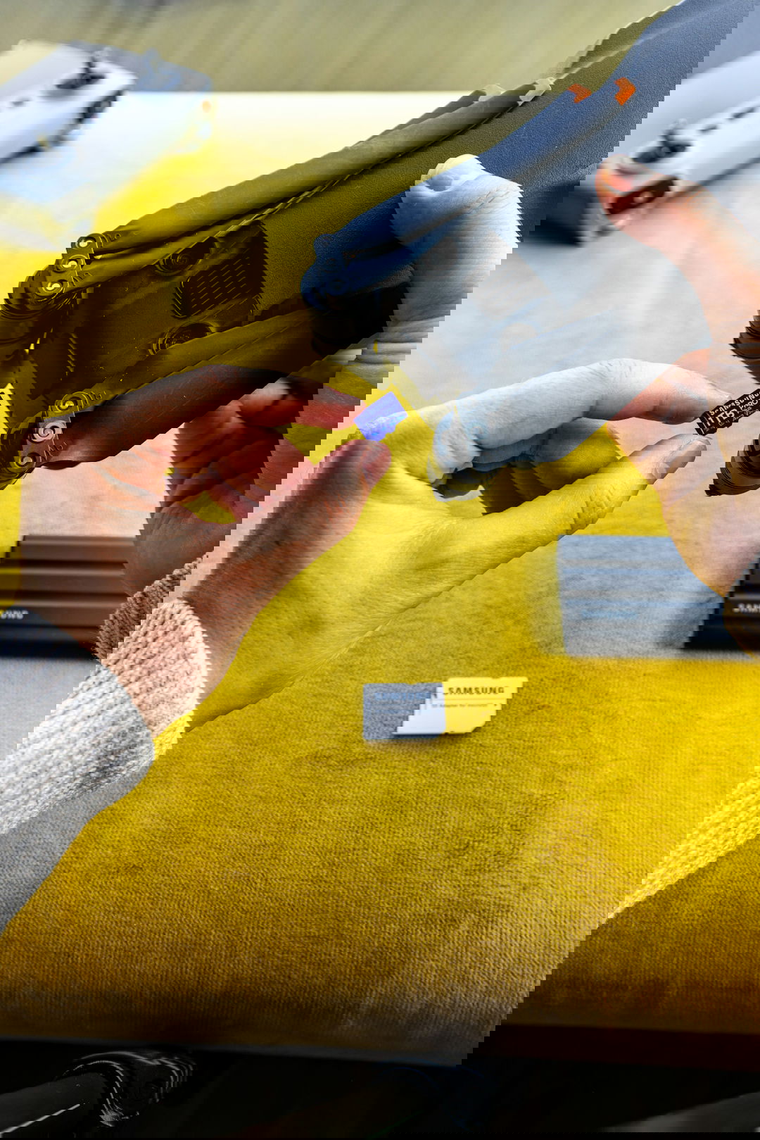 Hands inserting microsd card into drone